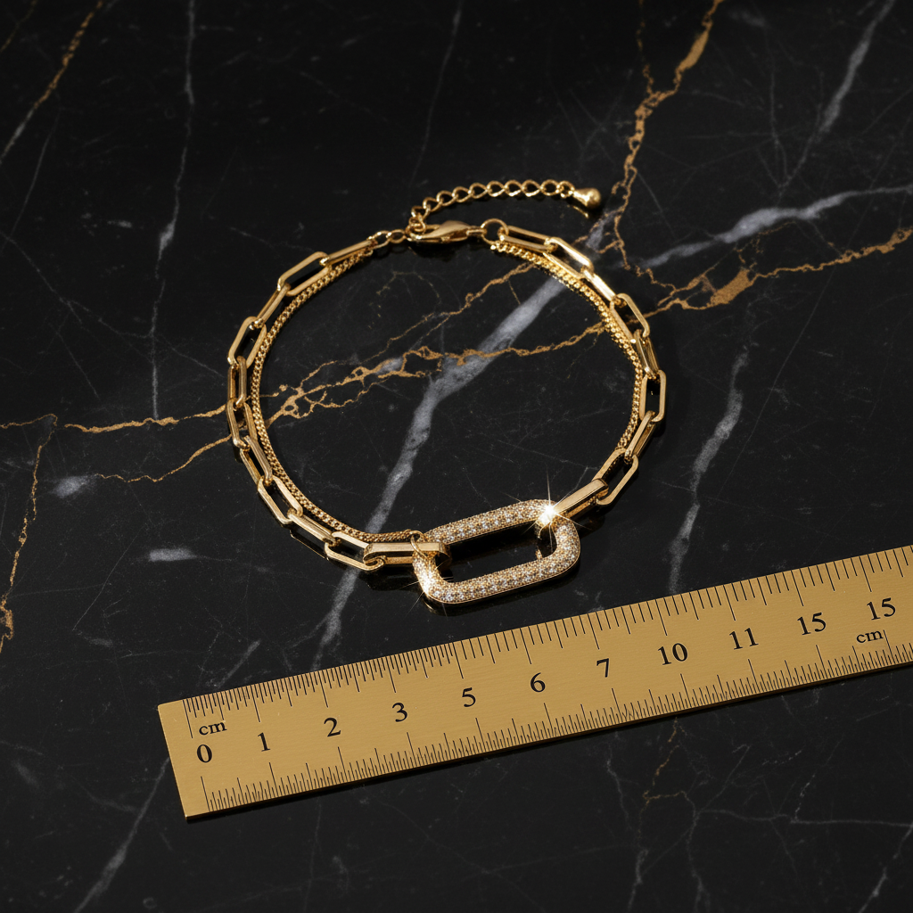 Double-layer gold chain bracelet measurement reference with gold ruler on black and gold marble