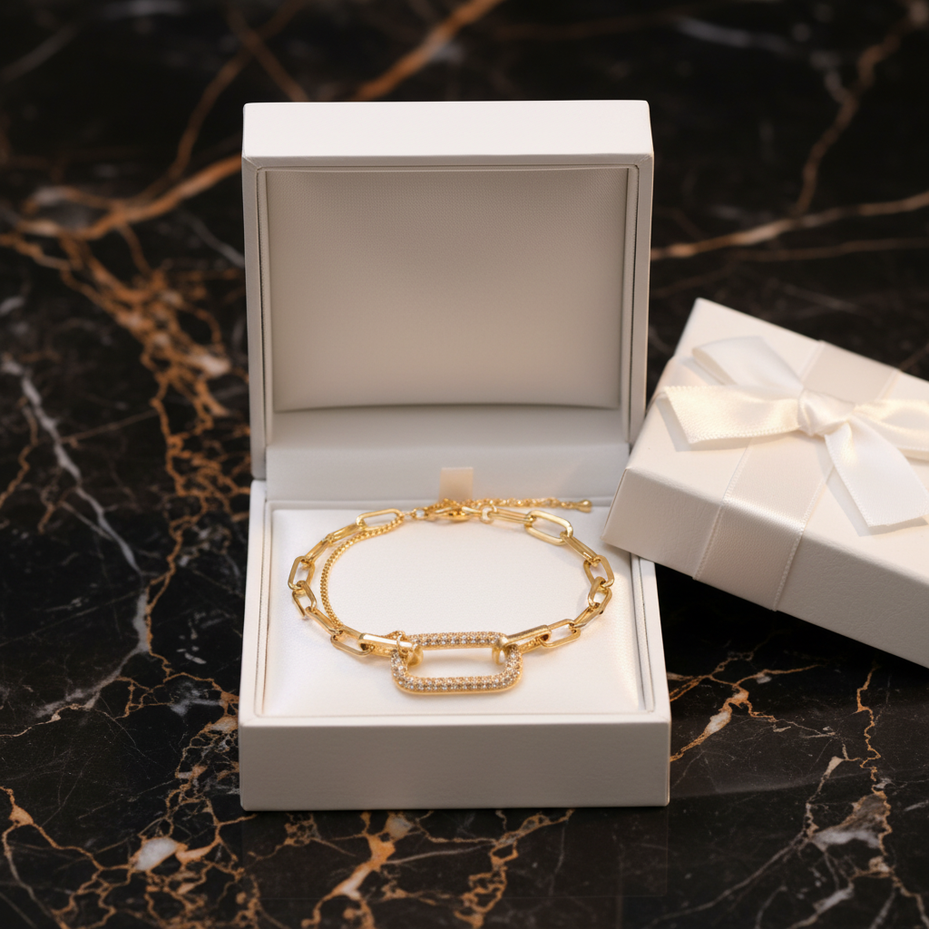 Double-layer gold chain bracelet in white luxury gift box on black and gold marble